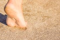 A Beautiful foot footprints in the sand killing on nature background