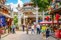 Beautiful foreigner street full of people with colorful old buildings and stone archway in Dali old town Yunnan China Royalty Free Stock Photo