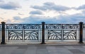 Beautiful forged railing on pavement paved with ceramic tiles. Royalty Free Stock Photo