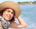 Beautiful forty year old woman with straw hat