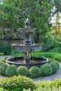 Beautiful fountain in the garden with natural green tree gardening exterior for home and living achitecture decoration. Vintage an Royalty Free Stock Photo