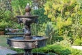 Beautiful fountain in the garden with natural green tree gardening exterior for home and living achitecture decoration. Vintage an Royalty Free Stock Photo