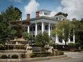 Beautiful fountain and historic antebellum mansion on sunny day in Wilmington NC Royalty Free Stock Photo