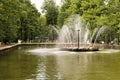 Petergof, Russia, July 2019. Fountain `Sun` in the middle of a park pond.