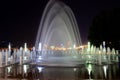 Beautiful fountain at night against blue sky. Evening view of Dnipro city. Creative water design, arched fountain, elegant Royalty Free Stock Photo