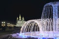 Beautiful fountains in city park. Colorful New Year garlands