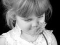 Beautiful Four Year Old Girl Smelling Flower Against Black Background Royalty Free Stock Photo