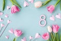 Beautiful frame from spring tulip flowers, number 8 and pink hearts for 8 March greeting card. International Women Day Royalty Free Stock Photo