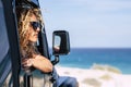 Beautiful free caucasian woman middle age enjoy the view outside the window off the car - concept of travel and live outdoor with Royalty Free Stock Photo