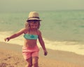 Beautiful free kid girl walking in the beach. Instagram effect portrait