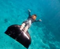 Beautiful freediver girl swims above sea bottom