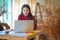 Beautiful freelancer female talking in a video conference on lin Royalty Free Stock Photo