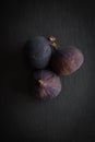 Beautiful fresh blue violet figs on dark stone background Royalty Free Stock Photo