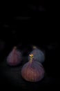 Beautiful fresh blue violet figs on dark stone background Royalty Free Stock Photo