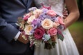 Bouquet of flowers in the hands of the bride with the groom
