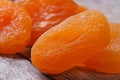 Beautiful fresh dried apricots close up on an old wooden table.