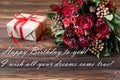 Beautiful fresh flower arrangement of red roses, gift box and text wish, birthday greeting card concept. Royalty Free Stock Photo