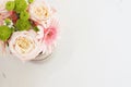 Beautiful fresh flowers on light marble table, top view. Pink roses and gerberas on a female work desk. Blogger lifestyle Royalty Free Stock Photo