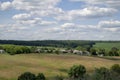 Beautiful, fresh morning in medieval mountain village with church in the middle, next to meadow. Farming in countryside between Royalty Free Stock Photo