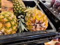 Beautiful fresh pineapples are being sold in a supermarket shelf in a supermarket