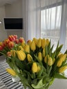 Beautiful fresh pink bouquet in green glass vase on table in warm room Royalty Free Stock Photo