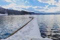 Beautiful fresh snow in winter around the mountains lake with blue sky background, Nagano Prefecture, Japan Royalty Free Stock Photo