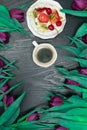 beautiful fresh spring tulip with cup of coffee and cake on dark background. Coffee time. Flower gift Royalty Free Stock Photo