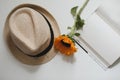 Beautiful fresh sunflower, straw hat and a book. Interior decoration. Summer concept. Flower card. Summer vacation time. Flat lay