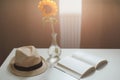 Beautiful fresh sunflower, straw hat and a book. Interior decoration. Summer concept. Flower card. Summer vacation time. Flat lay