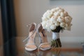 Beautiful fresh wedding bouquet with bride`s shoes Royalty Free Stock Photo