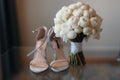 Beautiful fresh wedding bouquet with bride`s shoes Royalty Free Stock Photo
