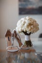 Beautiful fresh wedding bouquet with bride`s shoes Royalty Free Stock Photo