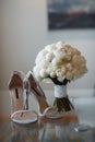 Beautiful fresh wedding bouquet with bride`s shoes Royalty Free Stock Photo