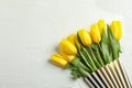 Beautiful fresh yellow tulips in cardboard box on light background Royalty Free Stock Photo