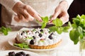 Food photo. Process of making tart. Closeup hands of chef with mint leaves