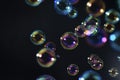 Beautiful fresness colorful soap bubbles floating in the dark. Black background. Royalty Free Stock Photo