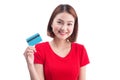 Beautiful friendly smiling asian girl showing credit card in han Royalty Free Stock Photo