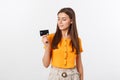 Beautiful friendly smiling confident girl showing black card in hand, isolated over white background. Royalty Free Stock Photo