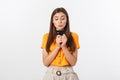 Beautiful friendly smiling confident girl showing black card in hand, isolated over white background. Royalty Free Stock Photo