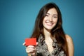 Beautiful friendly smiling confident girl showing red card in ha Royalty Free Stock Photo