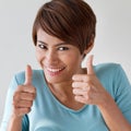 Beautiful, friendly, smiling woman giving two thumbs up Royalty Free Stock Photo