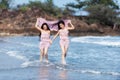 Beautiful friends enjoying a walk on the beach on a sunny day