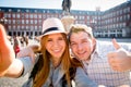 Beautiful friends tourist couple visiting Europe in holidays students exchange taking selfie picture