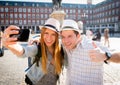 Beautiful friends tourist couple visiting Europe in holidays students exchange taking selfie picture Royalty Free Stock Photo