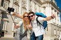 Beautiful friends tourist couple visiting Spain in holidays students exchange taking selfie picture