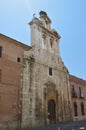 Beautiful Front Facade Of The Church Of Alcala De Henares University With A Nest Of Storks In Its Old Bell Tower. Architecture Tra Royalty Free Stock Photo