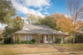 Beautiful front yard of typical single family houses near Dallas in fall season colorful leaves Royalty Free Stock Photo