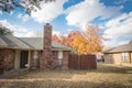 Beautiful front yard of typical single family houses near Dallas in fall season colorful leaves Royalty Free Stock Photo