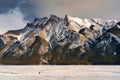 Beautiful frozen Lake Minnewanka with rocky mountains in winter on the evening at Banff national park Royalty Free Stock Photo