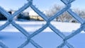 beautiful frozen wire fence outside in winter Royalty Free Stock Photo